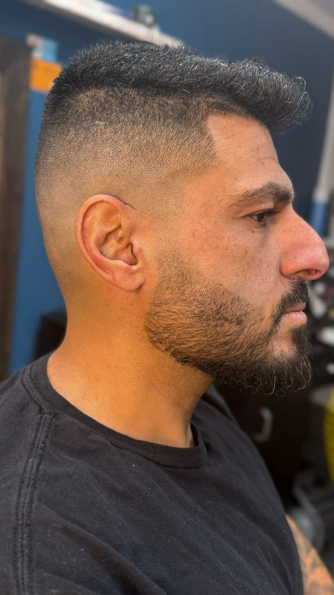 Mid fade with textured top and beard blend