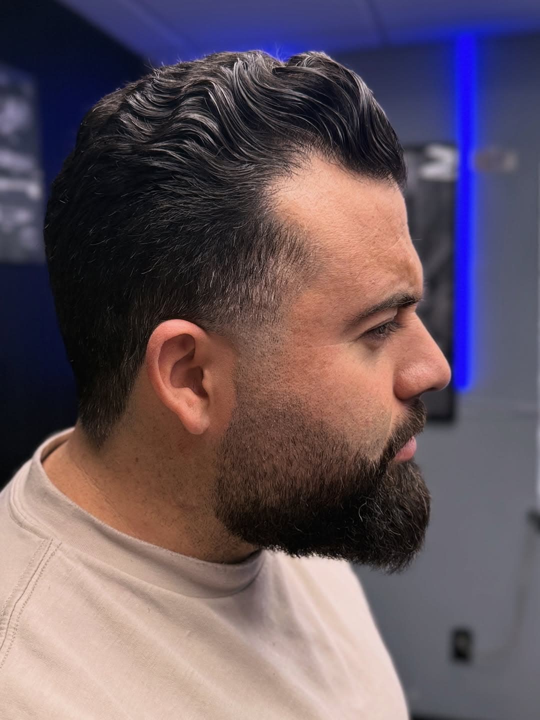 Classic slick back with mid fade and full beard