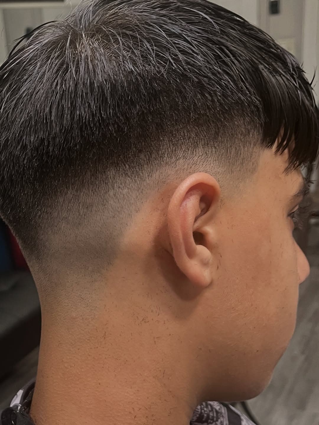 Skin fade with straight fringe and sharp blend